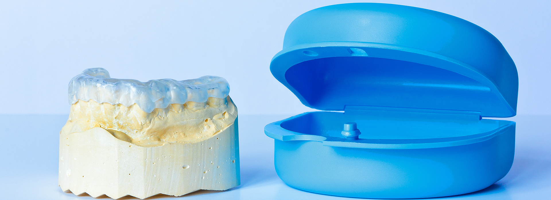 This image shows a blue dental model and a yellow dental model placed side by side.