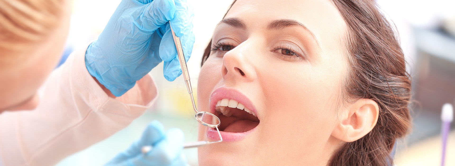 A person receiving dental care, with a focus on the process of fitting a dental implant.